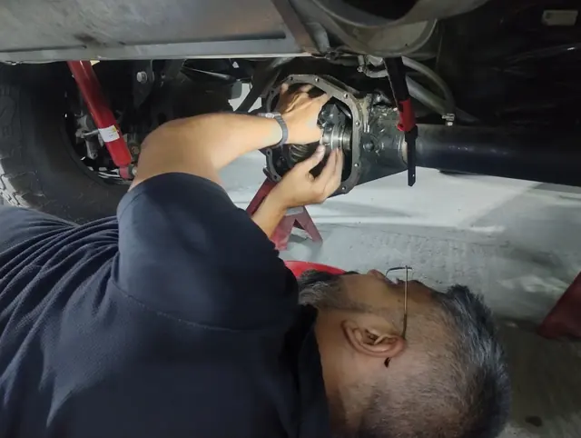 Working on the underside of a car on the lift