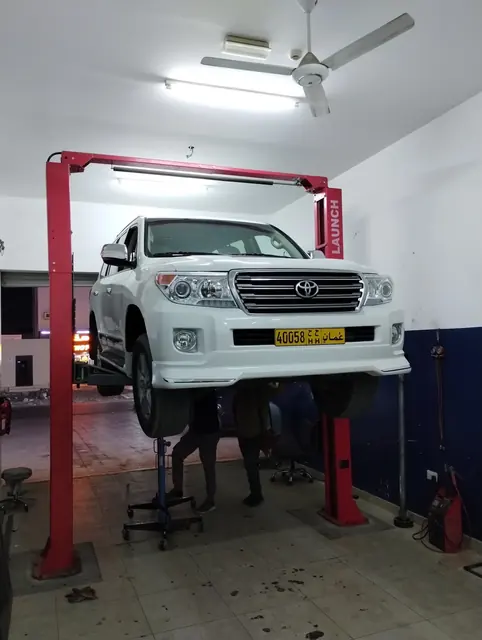 Toyota Land Cruiser raised on a two-post lift